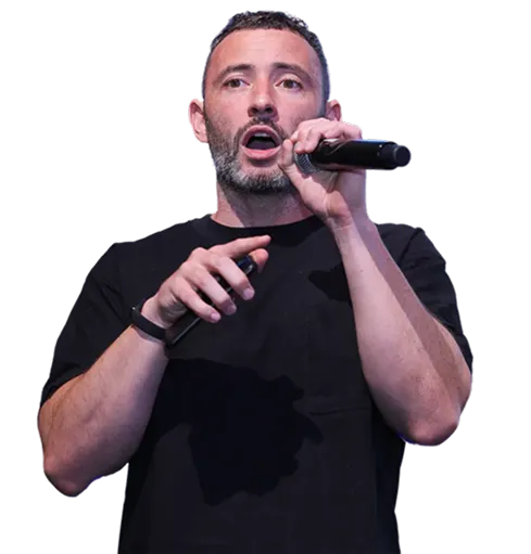 Speaker presenting on stage using AhaSlides interactive presentation software