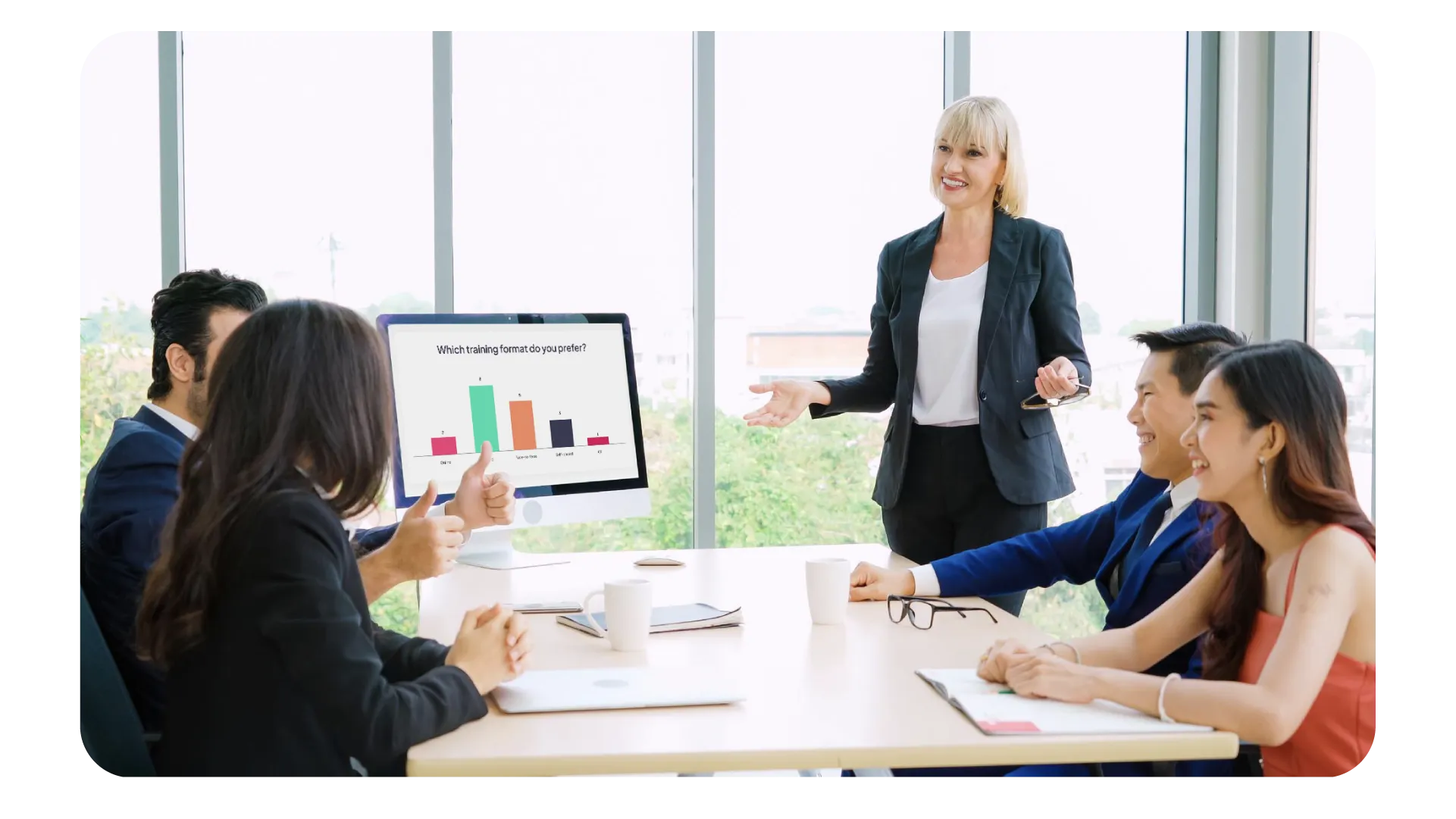 Smiling woman with glasses typing on a laptop in an office with text about adding interactive slides to a pitch deck and options for PDF and PPT import.