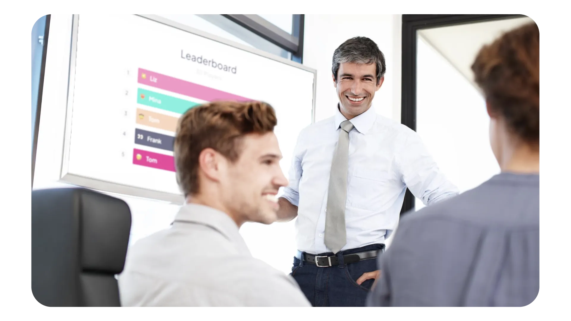 Person presenting in front a group of professionals with an AhaSlides leaderboard