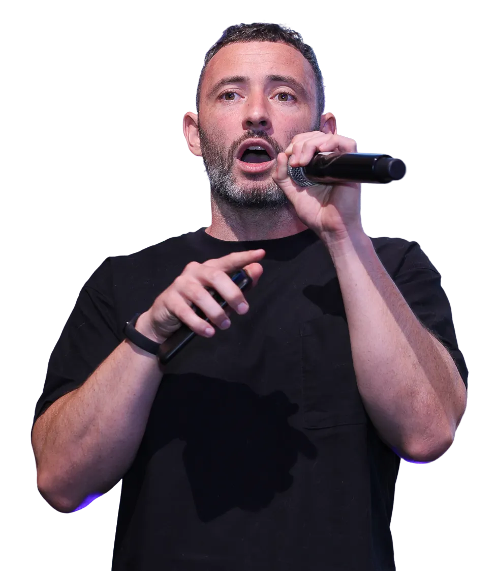 Speaker presenting on stage using AhaSlides interactive presentation software