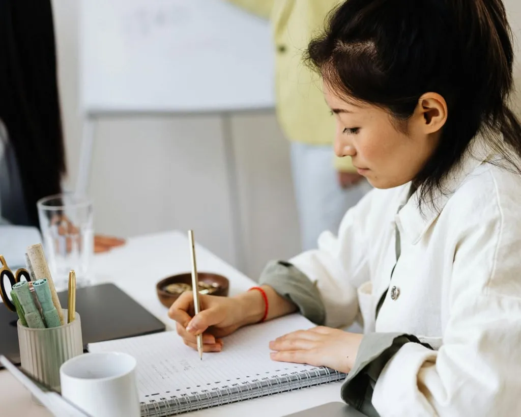 A woman is taking note during a training session.