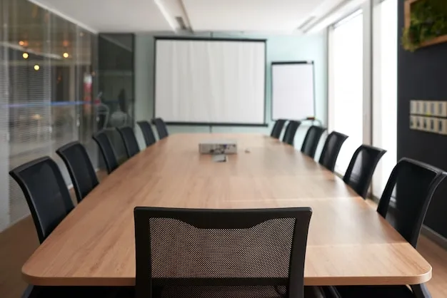 Meeting room with conference table and presentation screen for town hall meetings