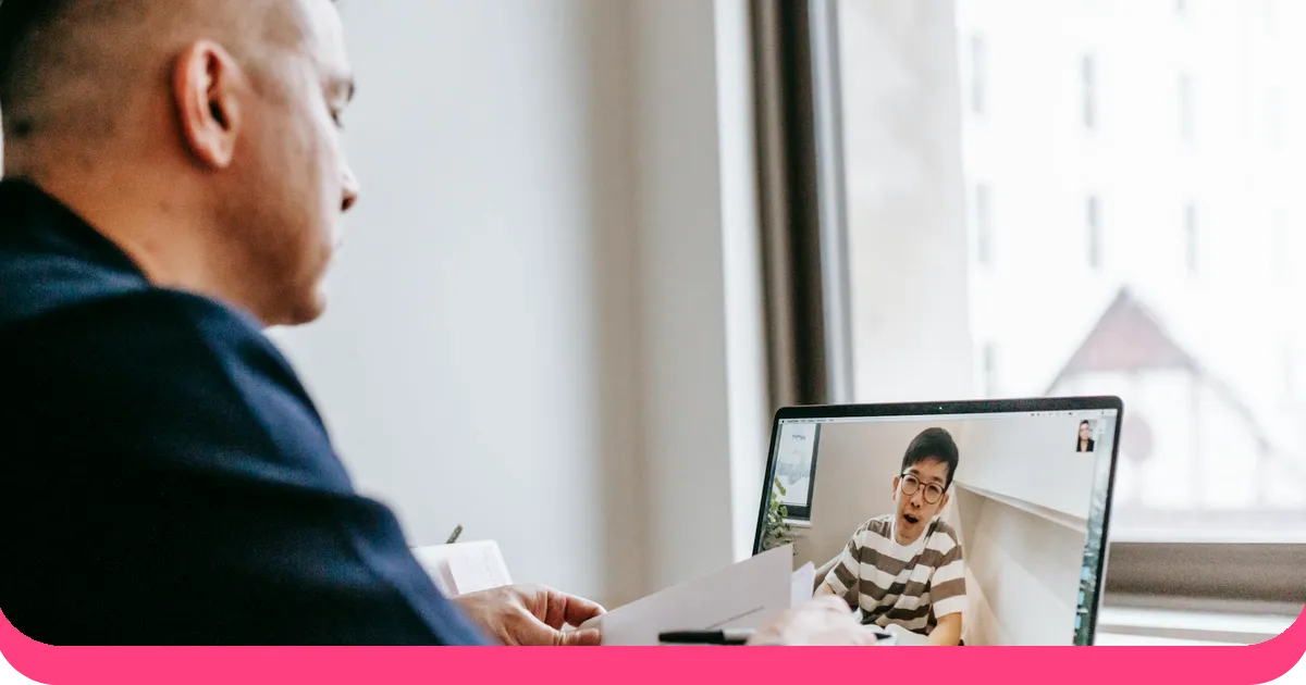 Professional conducting a virtual training session via video call on laptop with AhaSlides branding