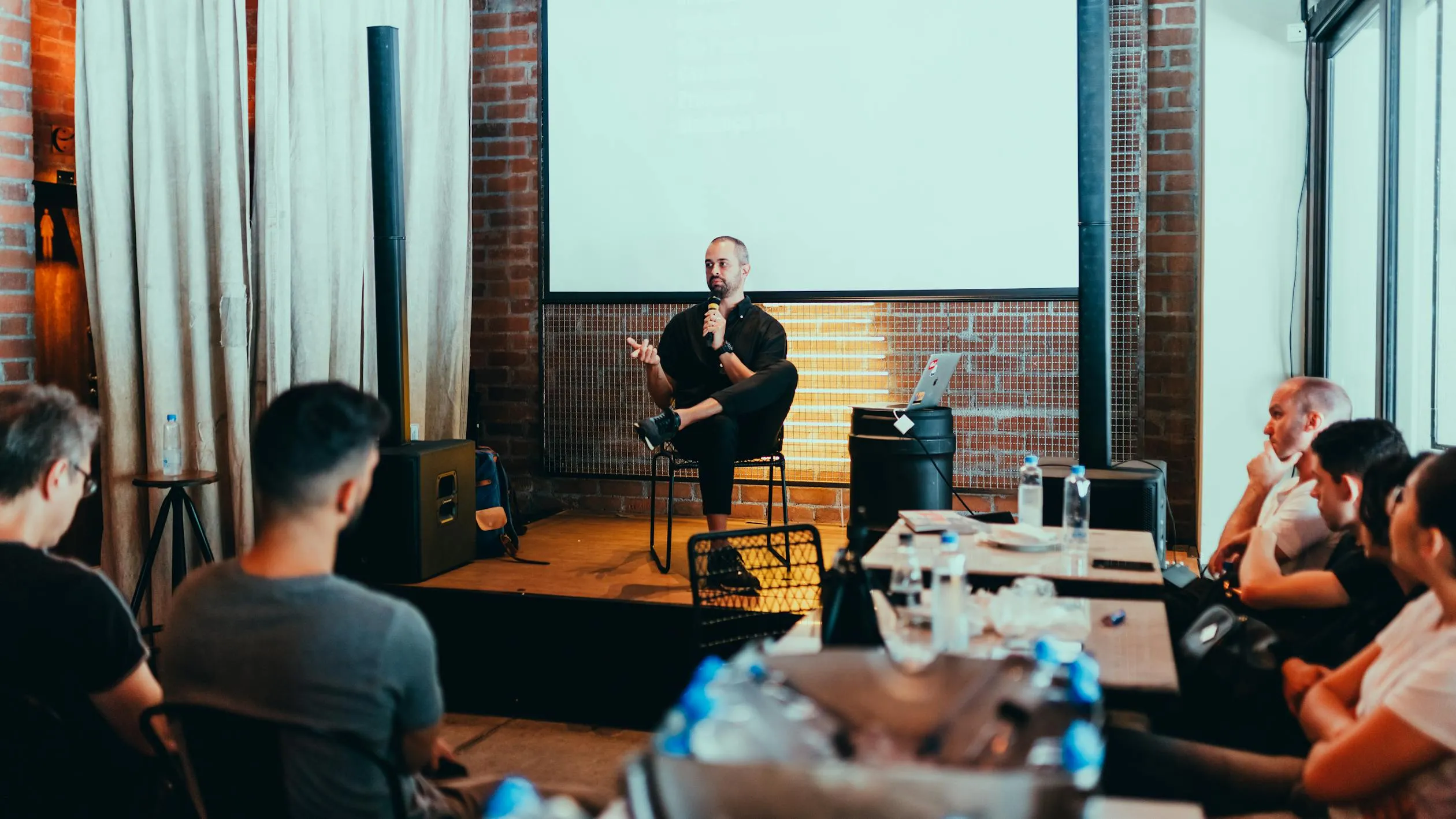 Speaker presenting confidently to an engaged audience at a professional event
