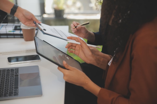 Employees reviewing survey feedback on a tablet and clipboard at a desk