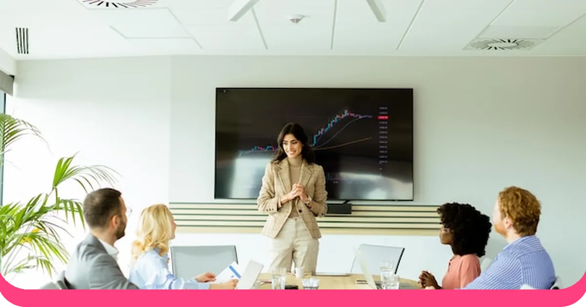 Woman presenting business data chart to colleagues at meeting table