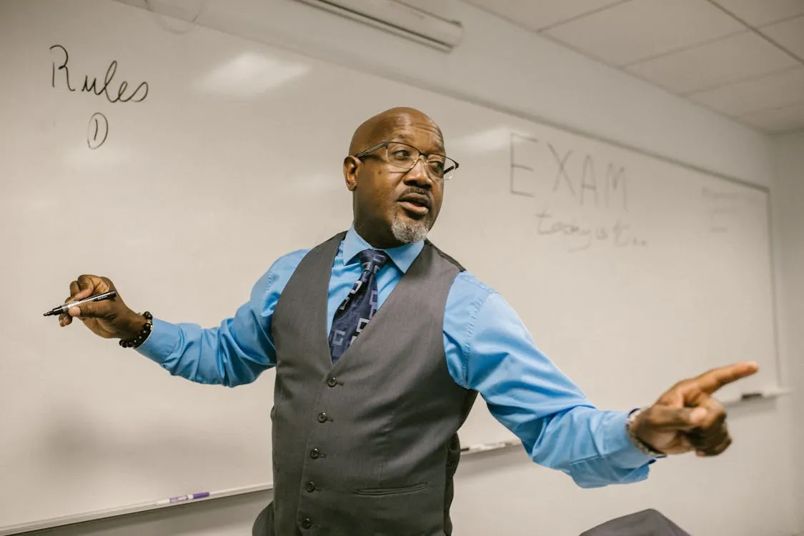 Professional trainer presenting and engaging with an audience at a whiteboard