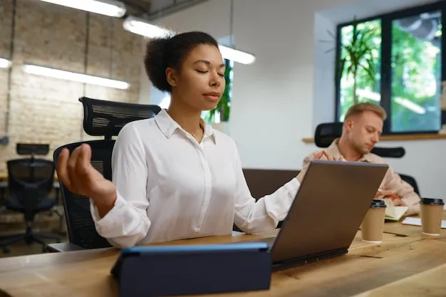 Office worker doing a calm breathing exercise at her desk