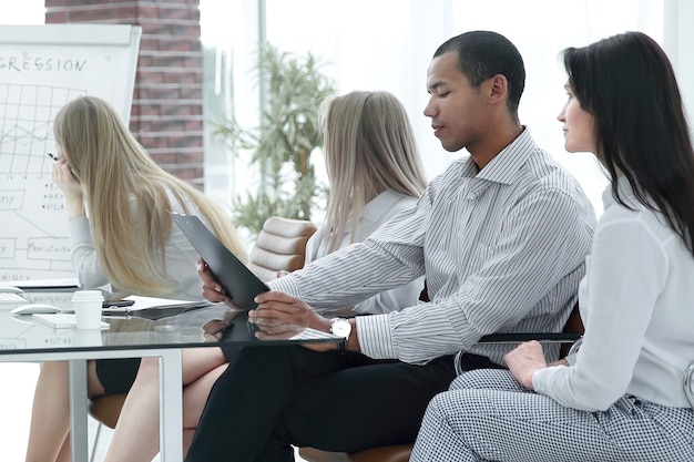 A diverse business team in a training session reviewing materials together