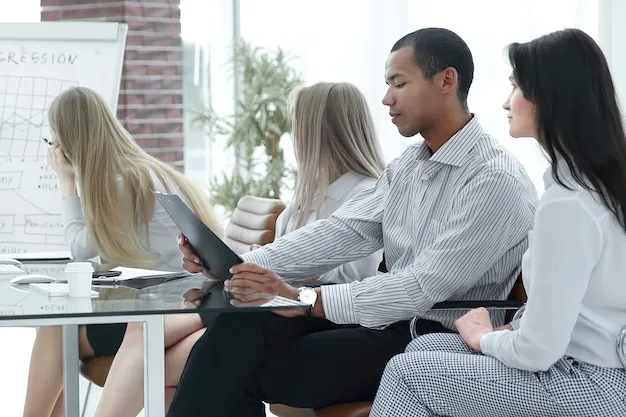 A diverse business team in a training session reviewing materials together