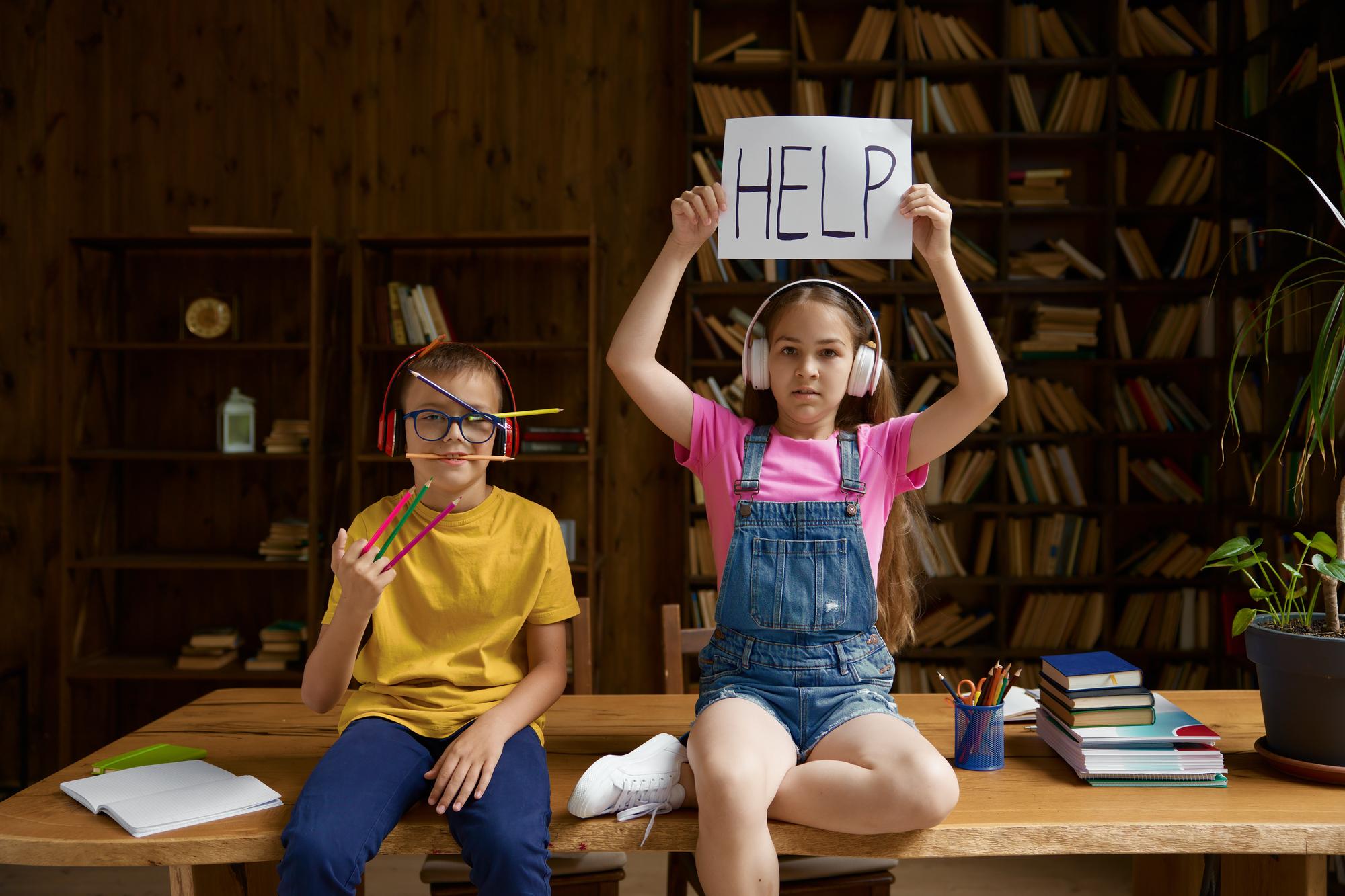 Kids answering quiz questions excitedly in a classroom