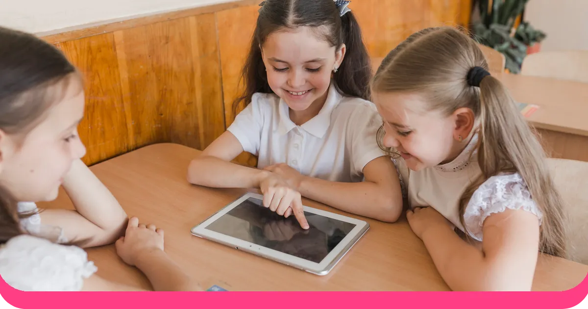 Children playing educational game on tablet in classroom