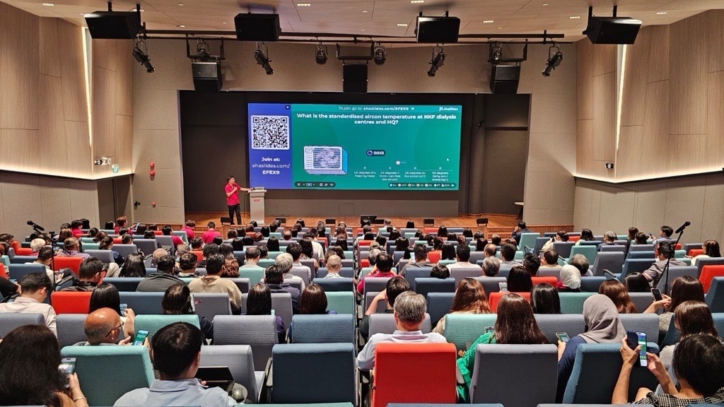 Someone is doing a presentation using AhaSlides in front of an audience in an auditorium
